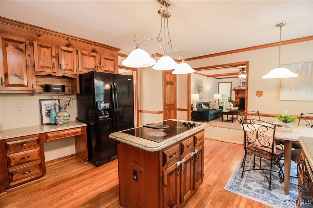 8510 Katy Reid Road Chesterfield, VA 23832 - Photo 12 of 50 a kitchen with stainless steel appliances granite countertop a stove top oven a refrigerator a dining table and chairs with wooden floor