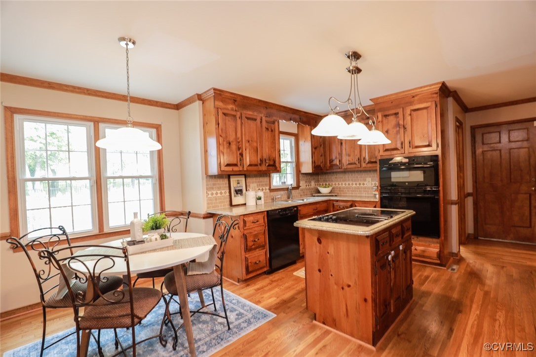 8510 Katy Reid Road Chesterfield, VA 23832 - Photo 9 of 50 a kitchen with stainless steel appliances granite countertop a stove oven a dining table and chairs with wooden floor