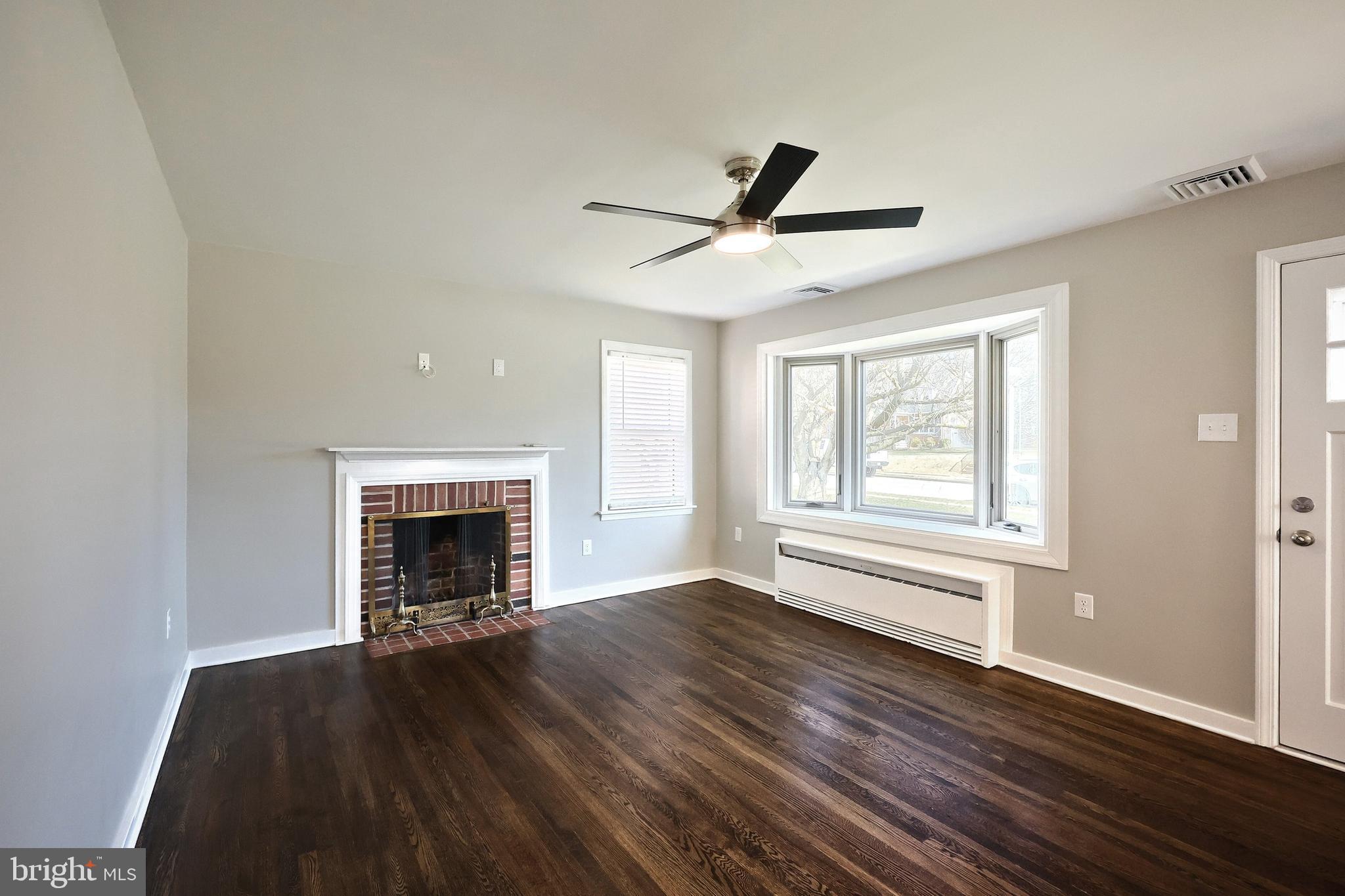 106 North Williams Street York, PA 17404 - Photo 16 of 42 a view of empty room with wooden floor and fireplace