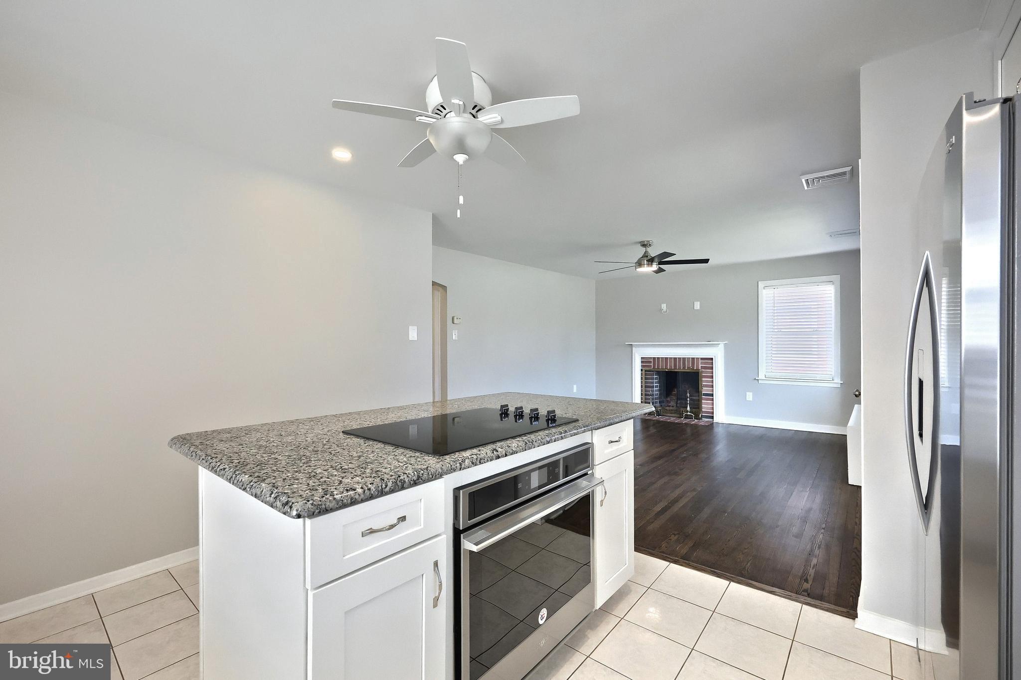 106 North Williams Street York, PA 17404 - Photo 20 of 42 a kitchen with granite countertop a stove cabinets and wooden floor
