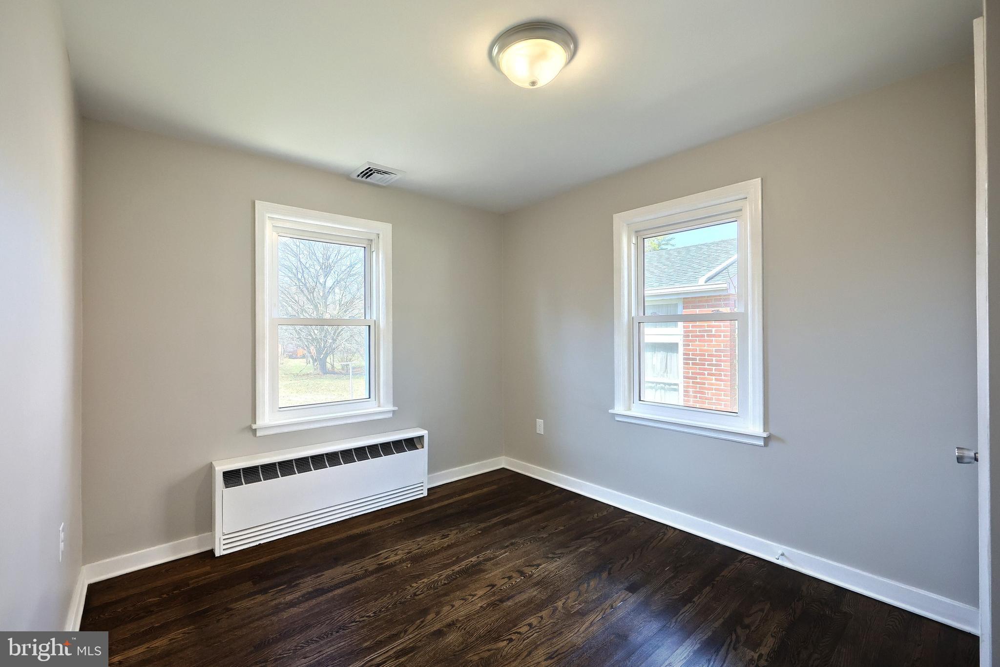 106 North Williams Street York, PA 17404 - Photo 22 of 42 an empty room with wooden floor and windows