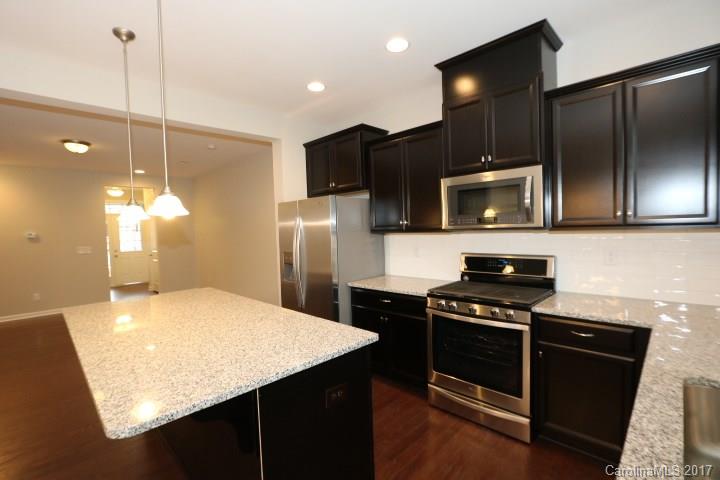 1108 Roderick Drive Fort Mill, SC 29708 - Photo 6 of 19 a kitchen with kitchen island a counter space a sink and stainless steel appliances