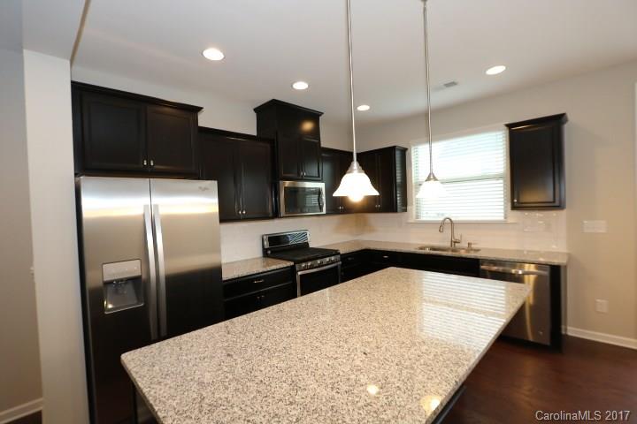 1108 Roderick Drive Fort Mill, SC 29708 - Photo 7 of 19 a kitchen with stainless steel appliances granite countertop a sink a stove and a refrigerator