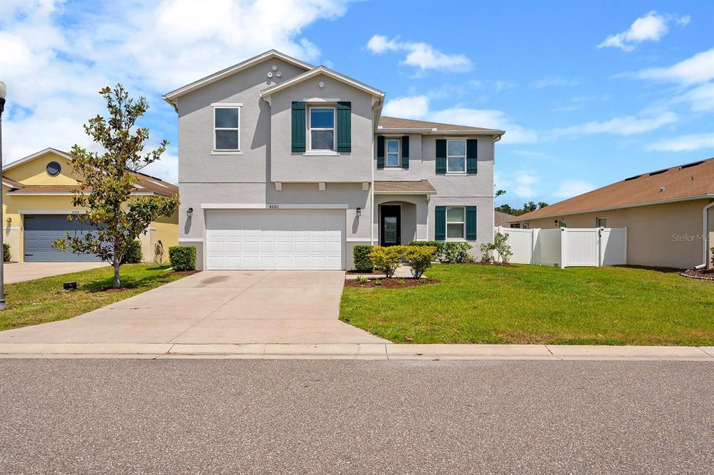 4280 Moon Shadow Loop Mulberry, FL 33860 - Photo 1 of 1 a front view of a house with a yard and garage