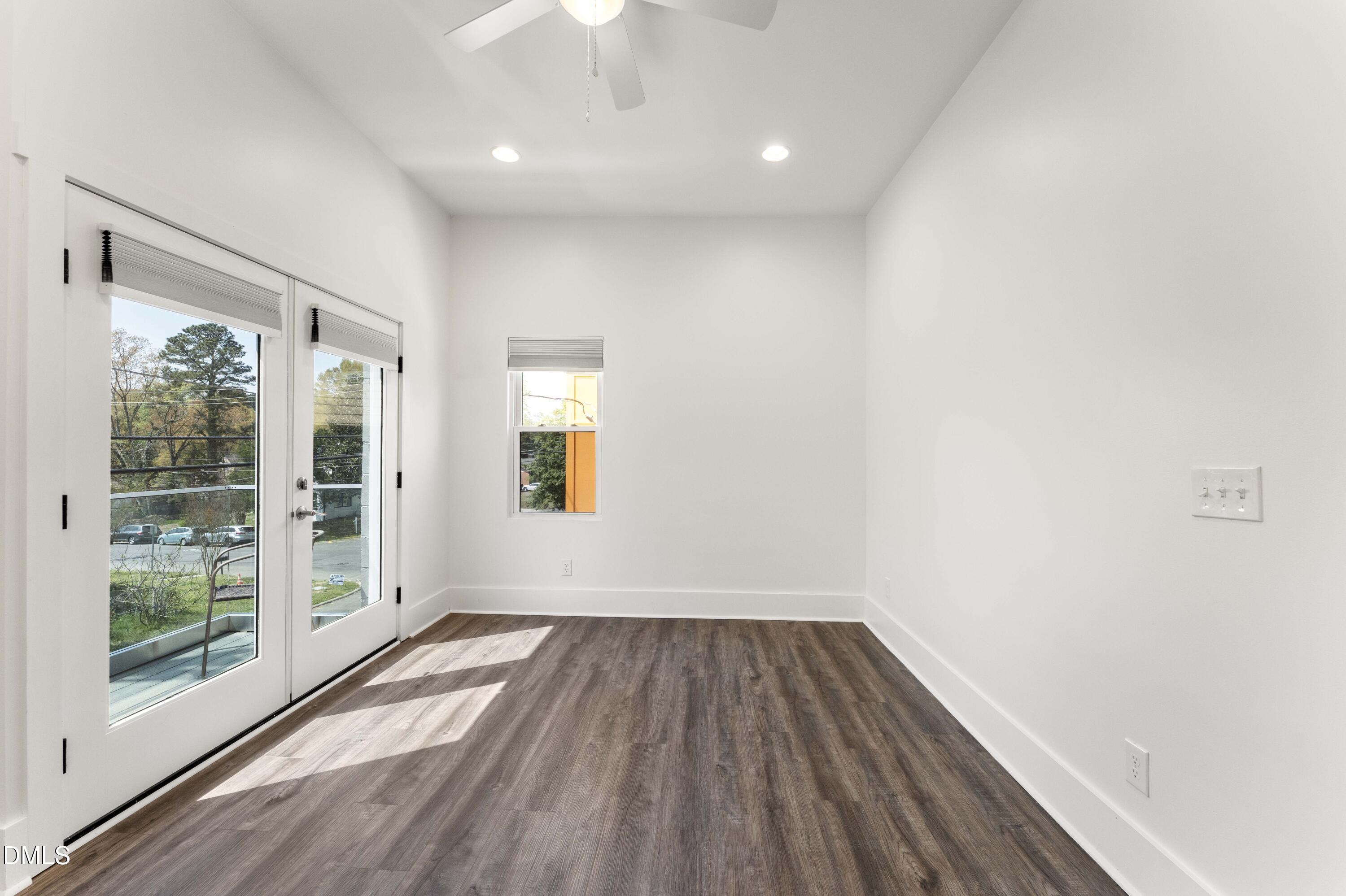 203 Nelson Street Durham, NC 27707 - Photo 14 of 29 a view of empty room with wooden floor and fan