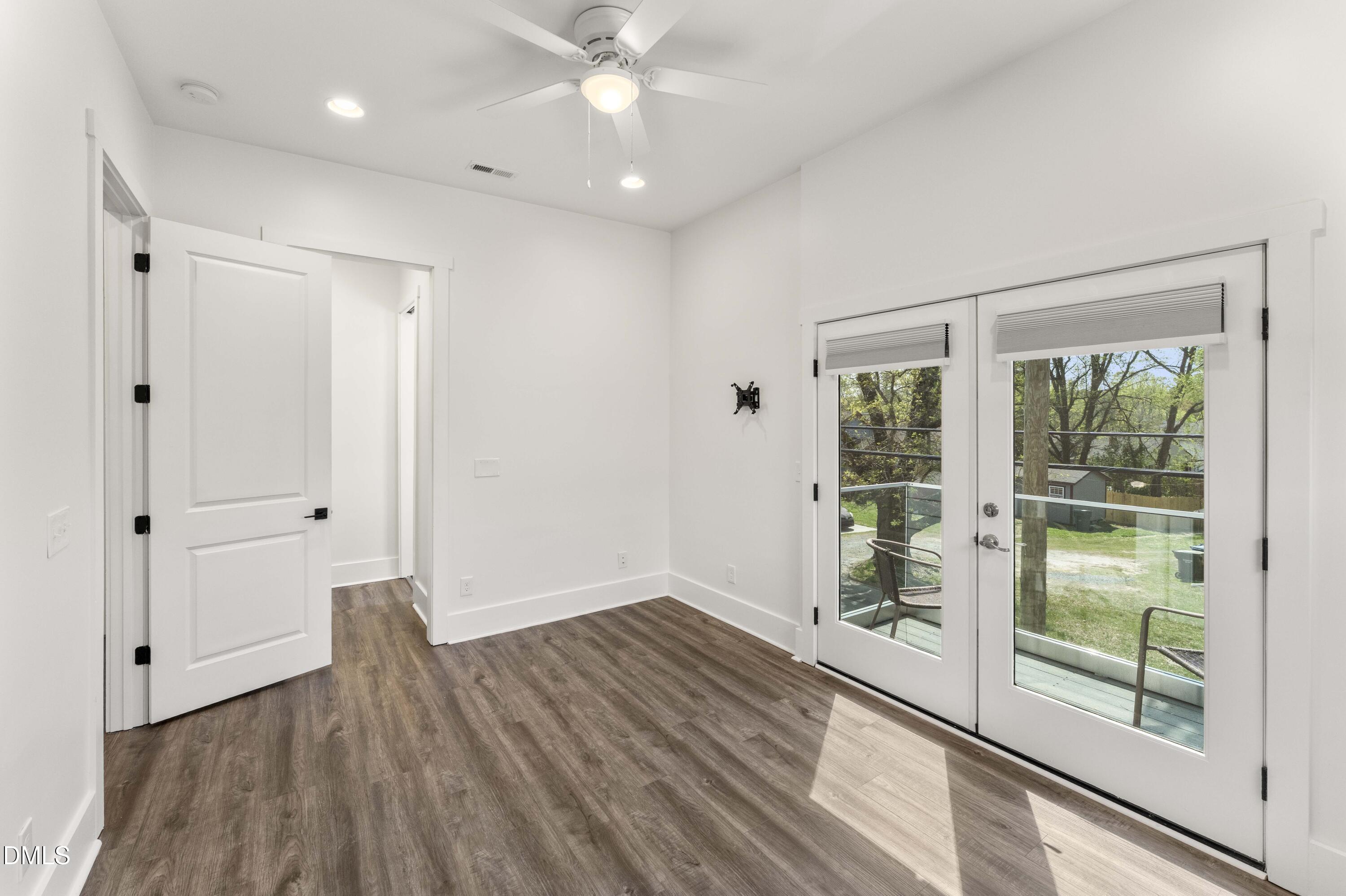 203 Nelson Street Durham, NC 27707 - Photo 16 of 29 a view of an empty room with glass door and a window