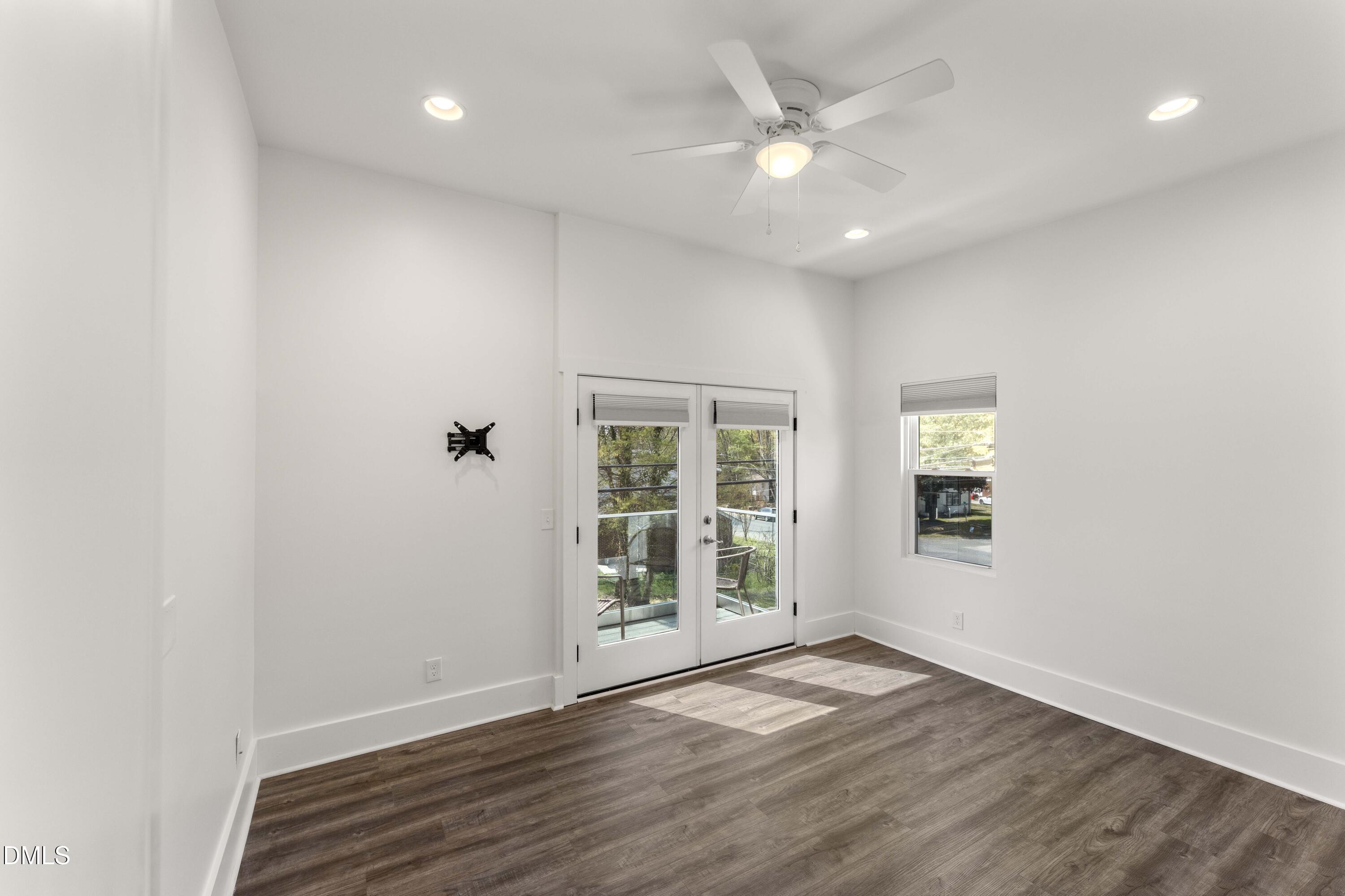 203 Nelson Street Durham, NC 27707 - Photo 17 of 29 an empty room with wooden floor and windows