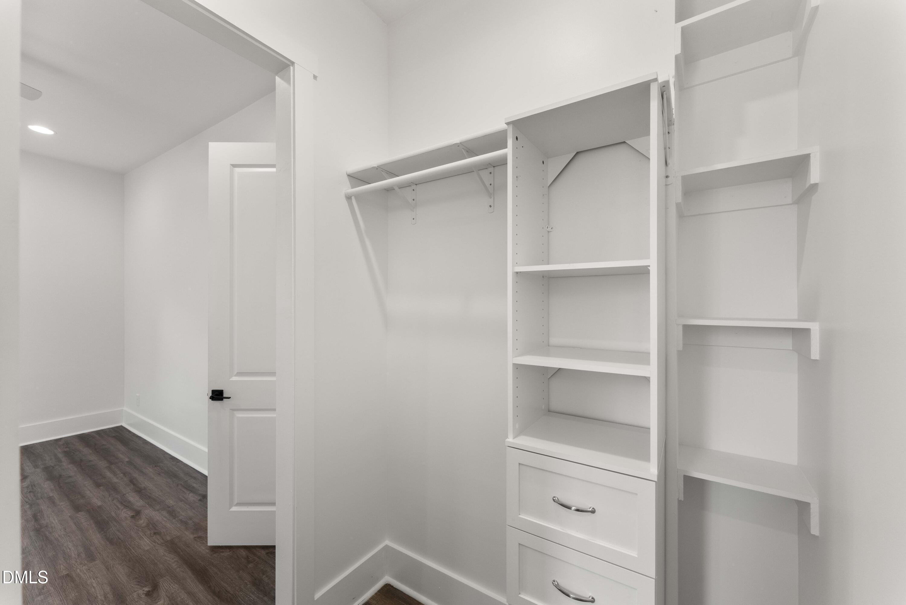 203 Nelson Street Durham, NC 27707 - Photo 21 of 29 a view of walk in closet with empty racks