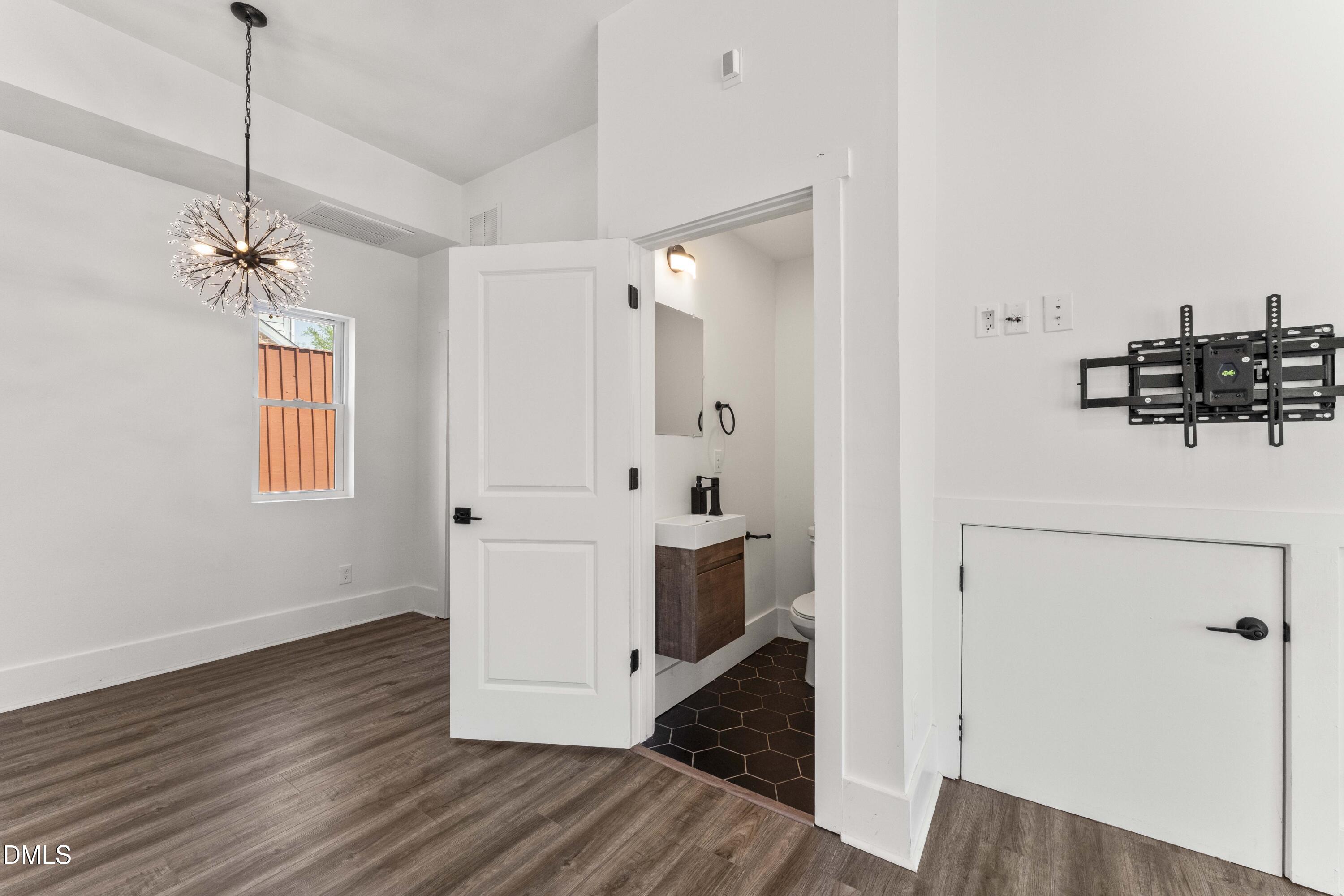 203 Nelson Street Durham, NC 27707 - Photo 8 of 29 a view of a hallway with wooden floor and staircase