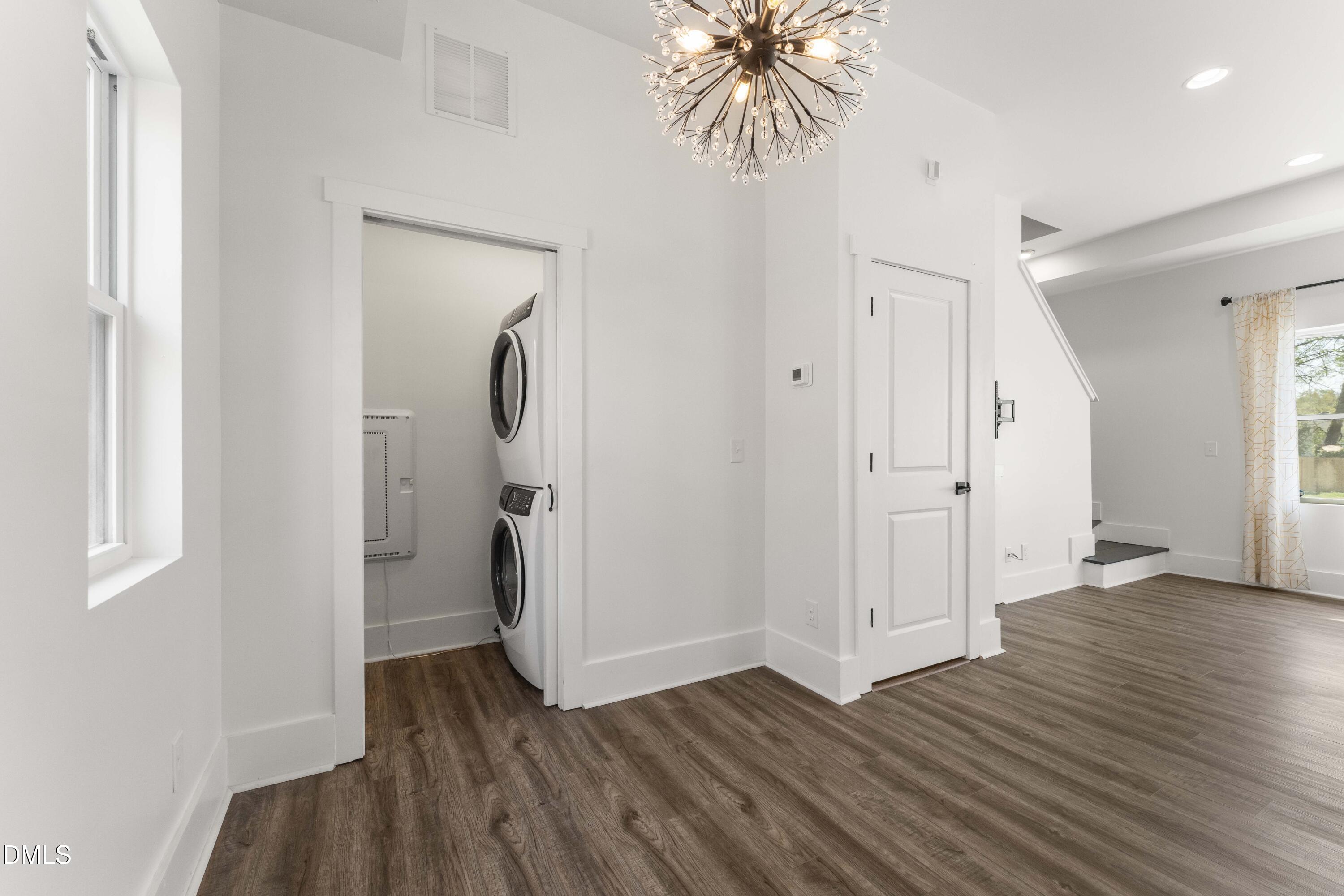 203 Nelson Street Durham, NC 27707 - Photo 10 of 29 a view of a hallway with wooden floor and closet