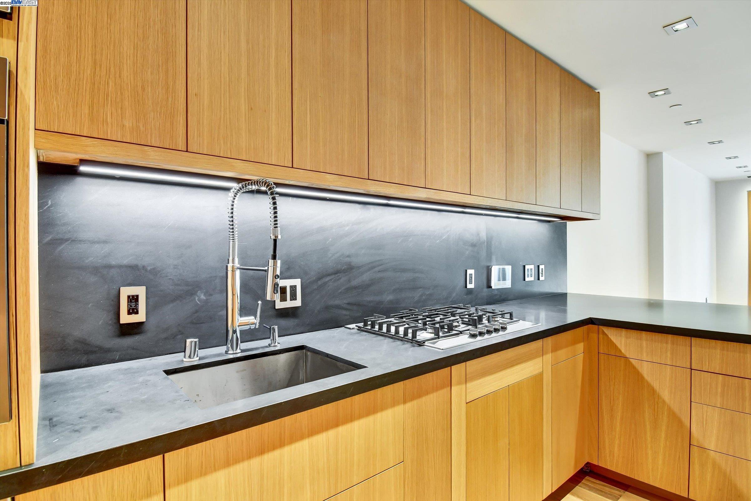 1208 Stanyan Street San Francisco, CA 94117 - Photo 14 of 60 a view of a kitchen with stainless steel appliances granite countertop a sink and cabinets