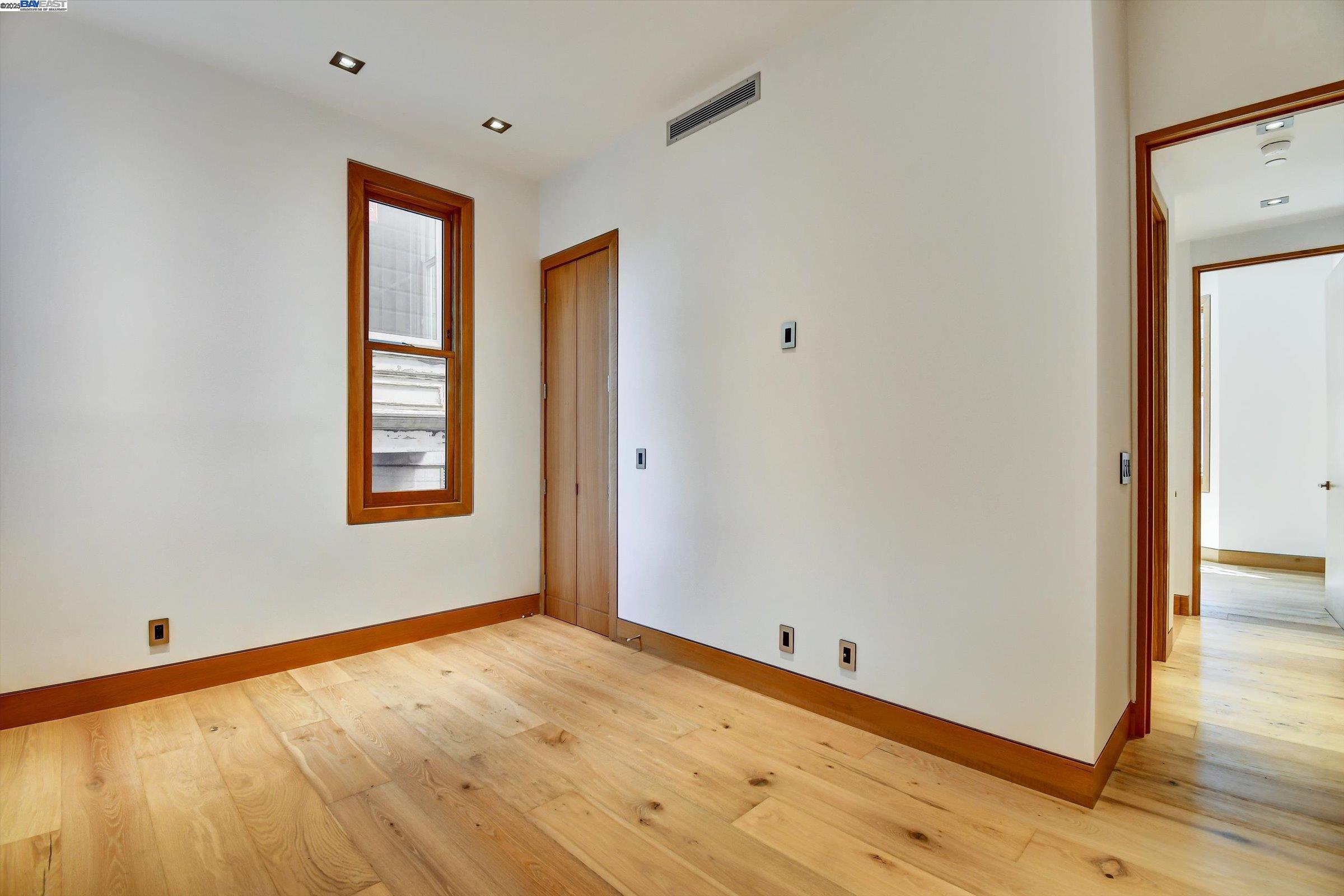 1208 Stanyan Street San Francisco, CA 94117 - Photo 23 of 60 a view of an empty room with wooden floor and a window