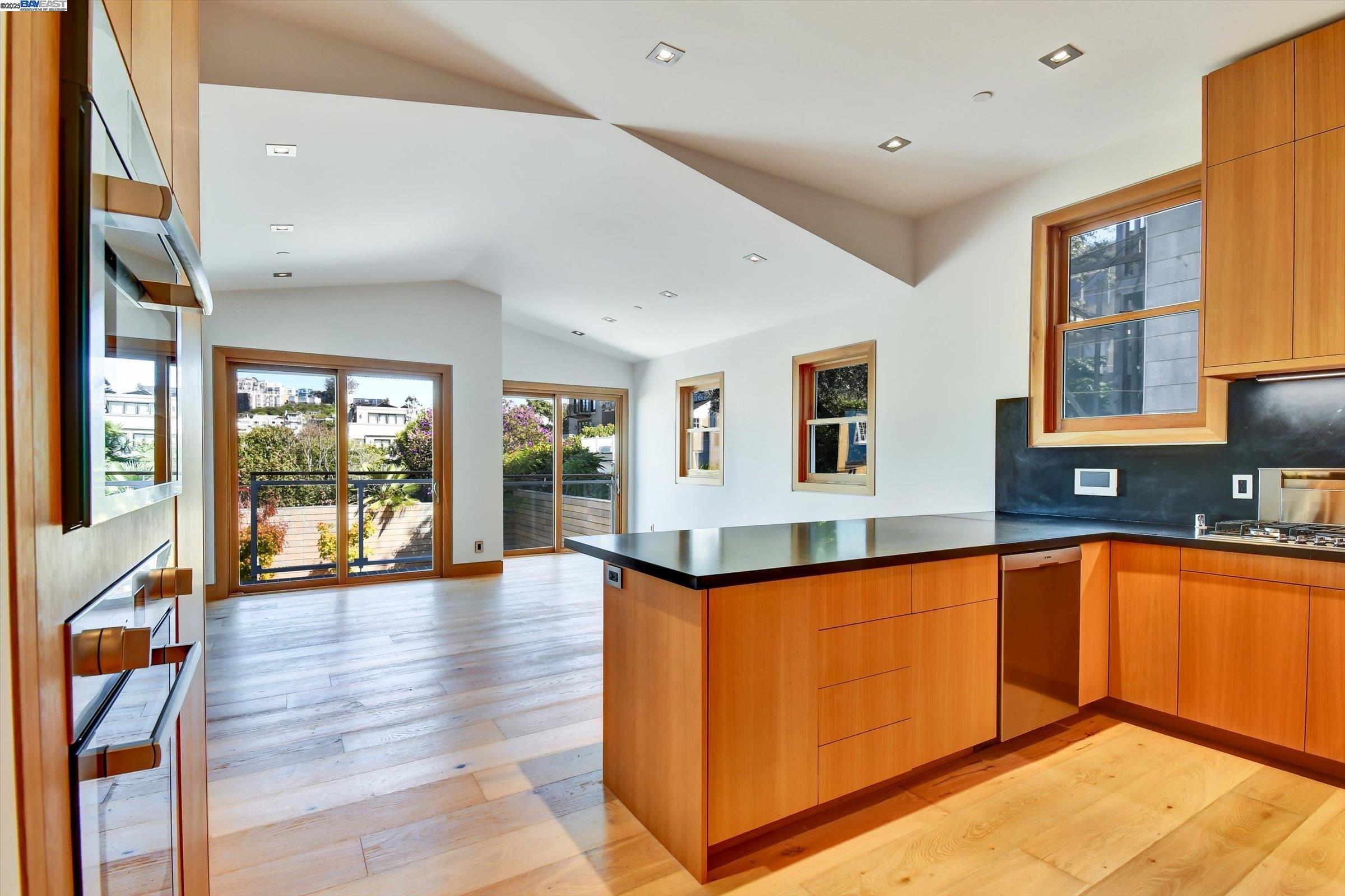 1208 Stanyan Street San Francisco, CA 94117 - Photo 25 of 60 a large kitchen with stainless steel appliances granite countertop a sink and cabinets