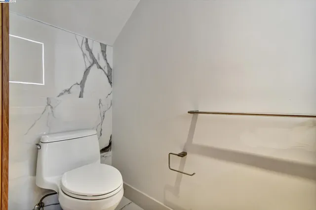 a bathroom with a granite countertop tub sink and mirror
