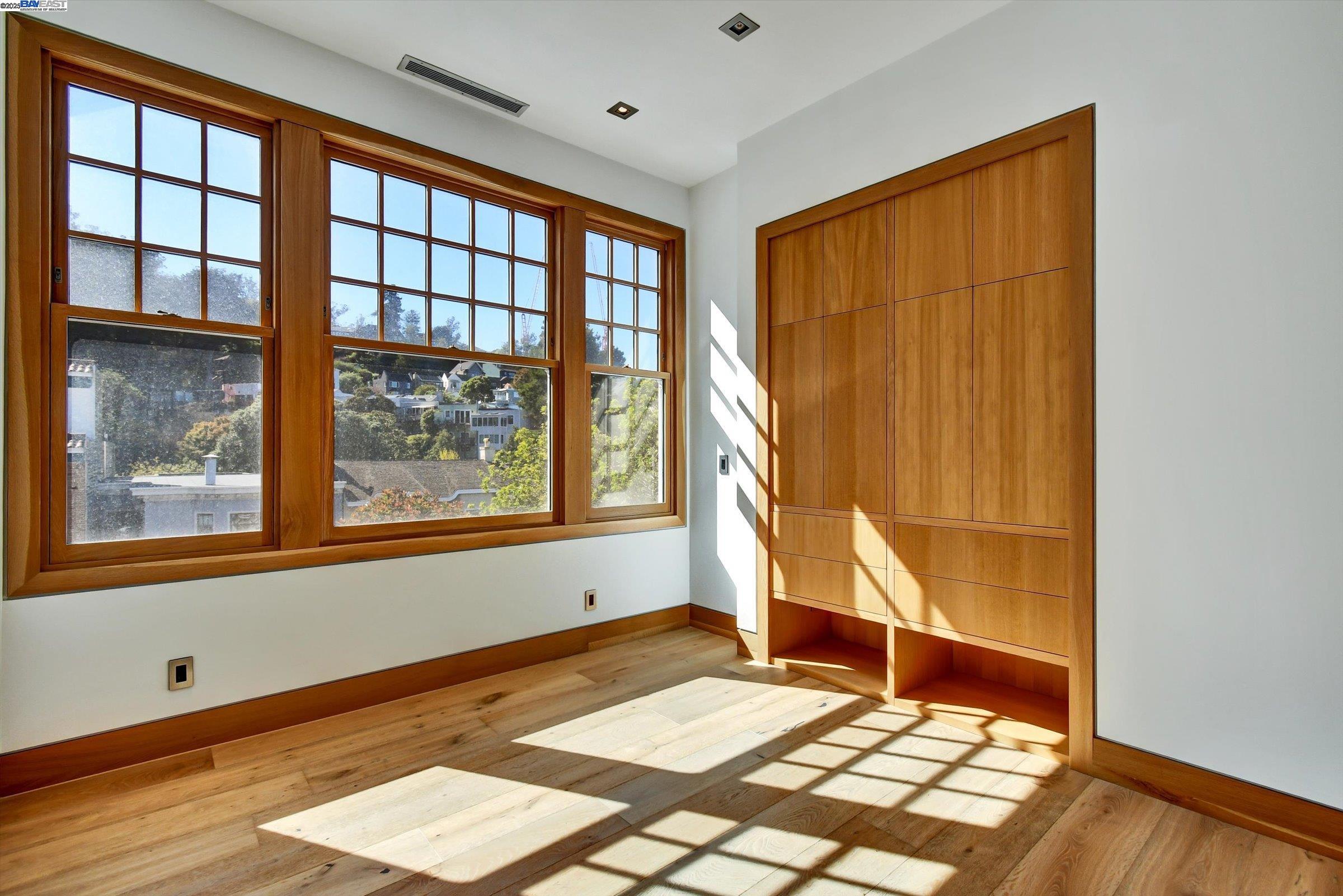 1208 Stanyan Street San Francisco, CA 94117 - Photo 41 of 60 a view of an empty room with wooden floor and a window
