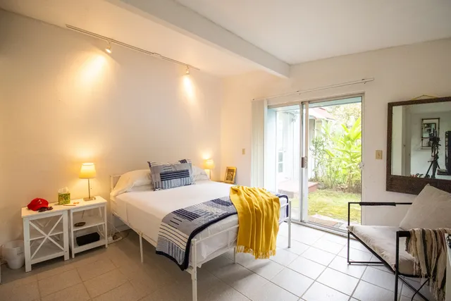 a bedroom with a bed and a window