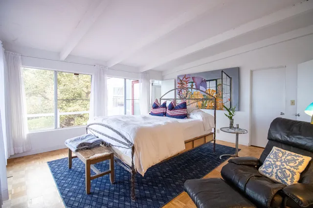 a bed room with a bed and a chair