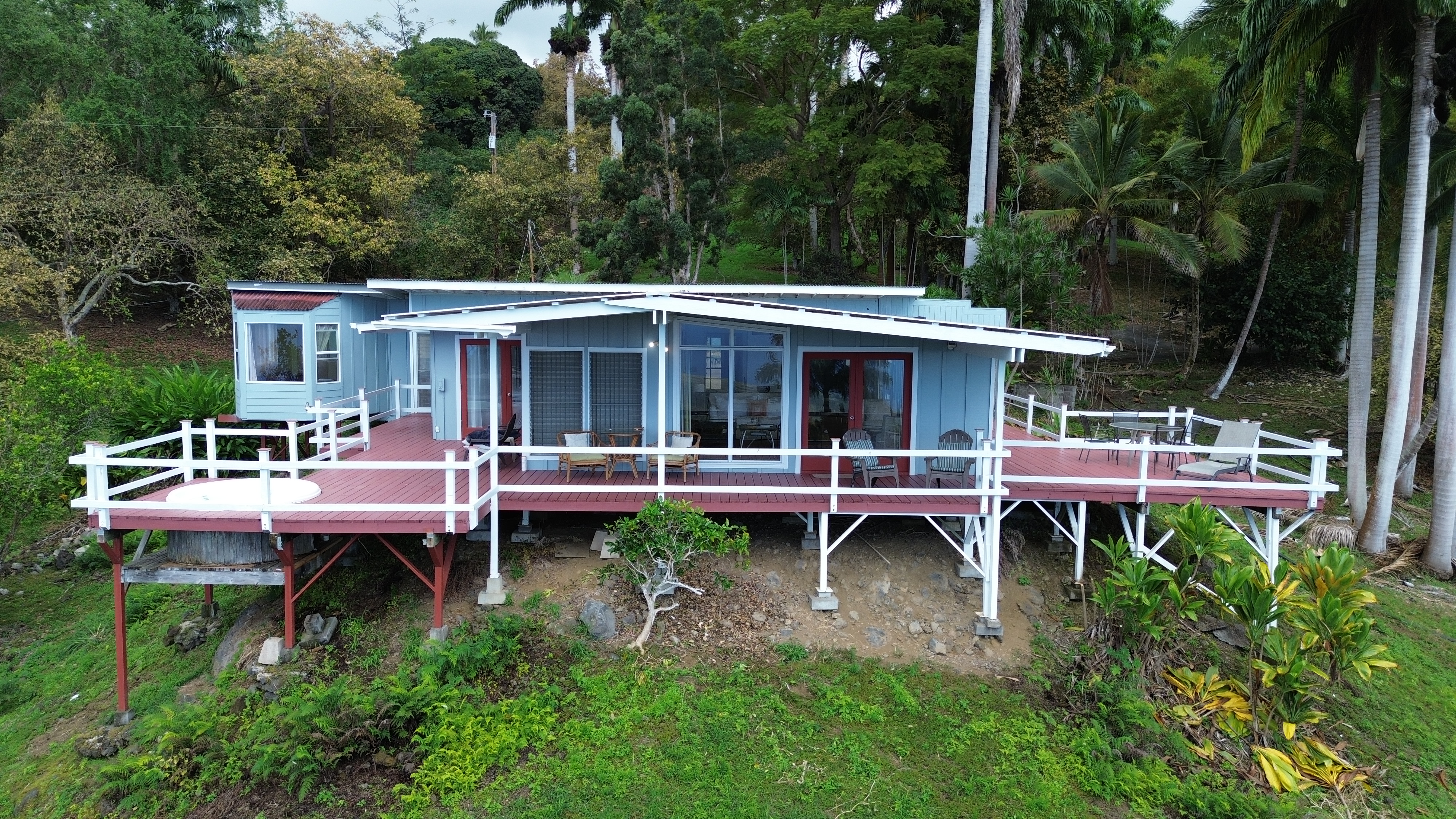 84-5063 Hawaii Belt Road Captain Cook, HI 96704 - Photo 2 of 30 a backyard of a house with yard fire pit table and chairs