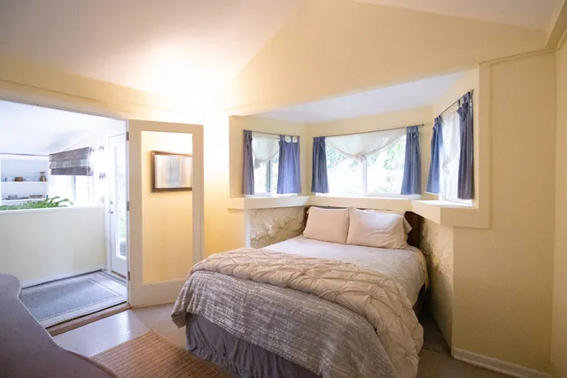 a bedroom with a bed and a window