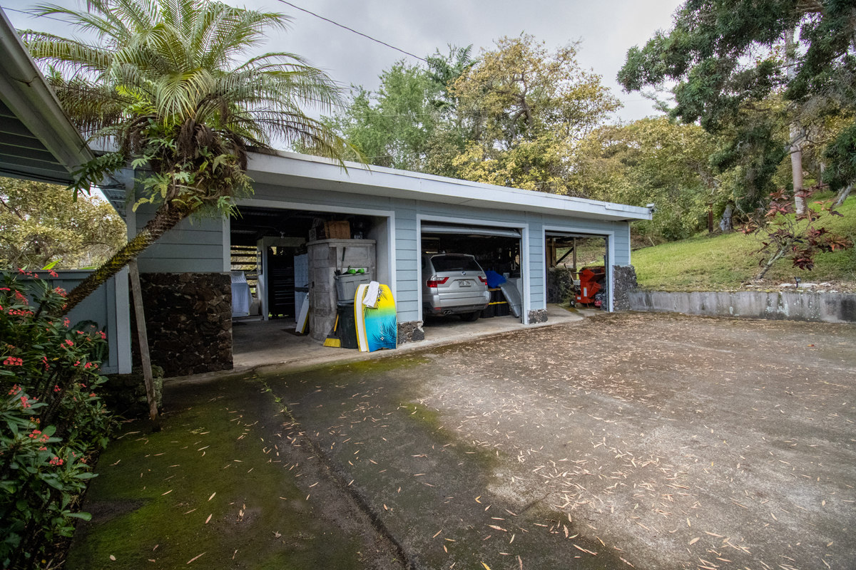 84-5063 Hawaii Belt Road Captain Cook, HI 96704 - Photo 6 of 30 a view of a house with large trees and a small yard