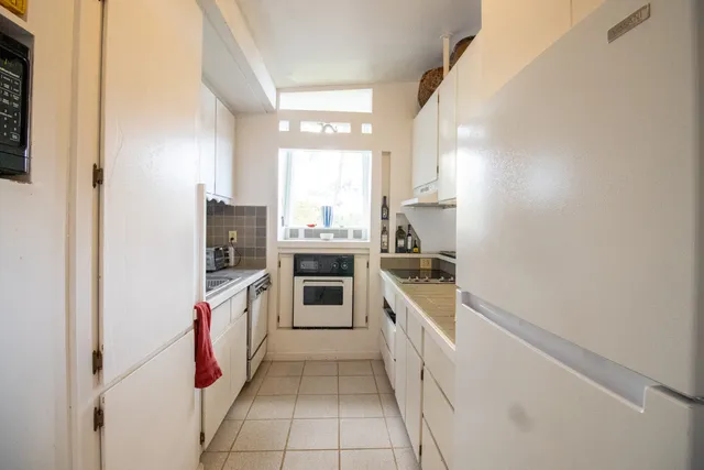 a kitchen with a sink stove and refrigerator