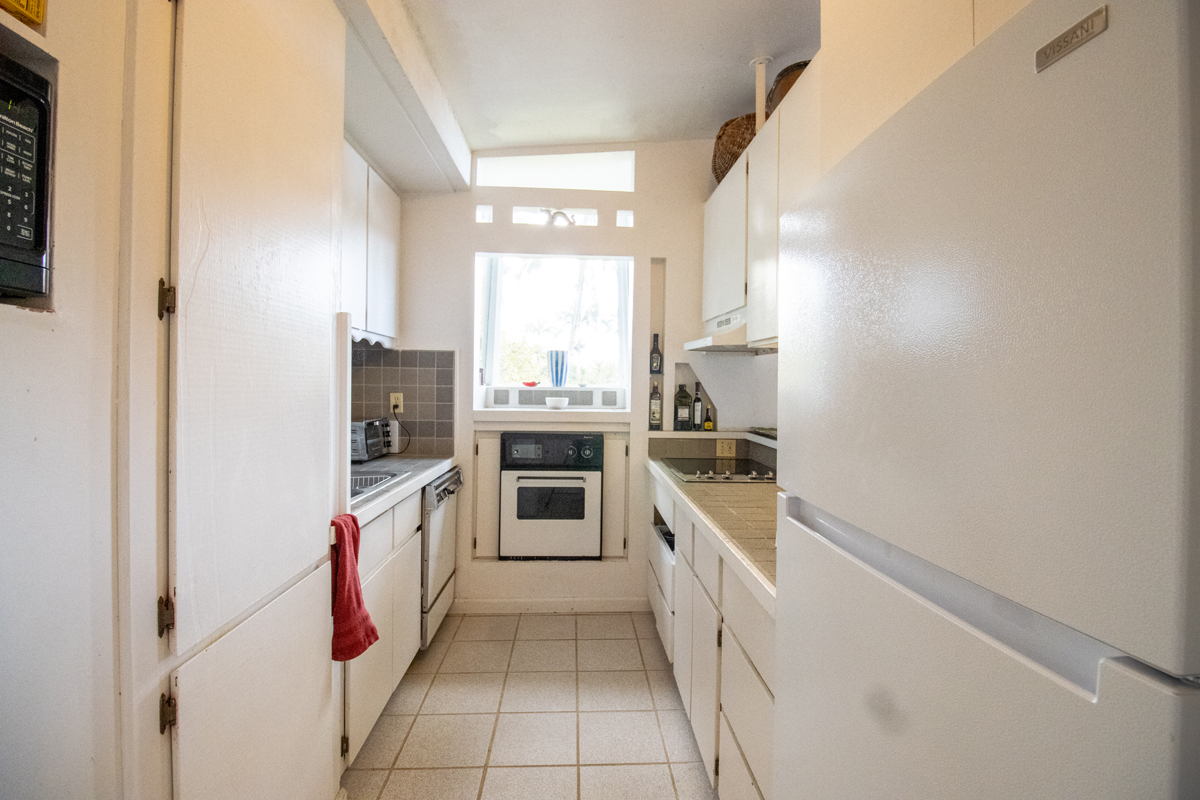 84-5063 Hawaii Belt Road Captain Cook, HI 96704 - Photo 9 of 30 a kitchen with a sink stove and refrigerator