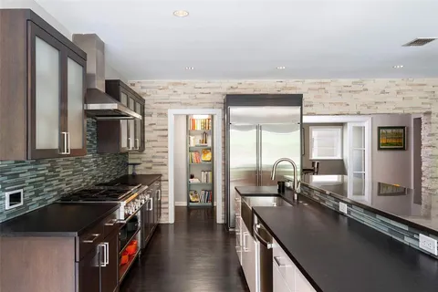 a kitchen with stainless steel appliances a sink stove and refrigerator