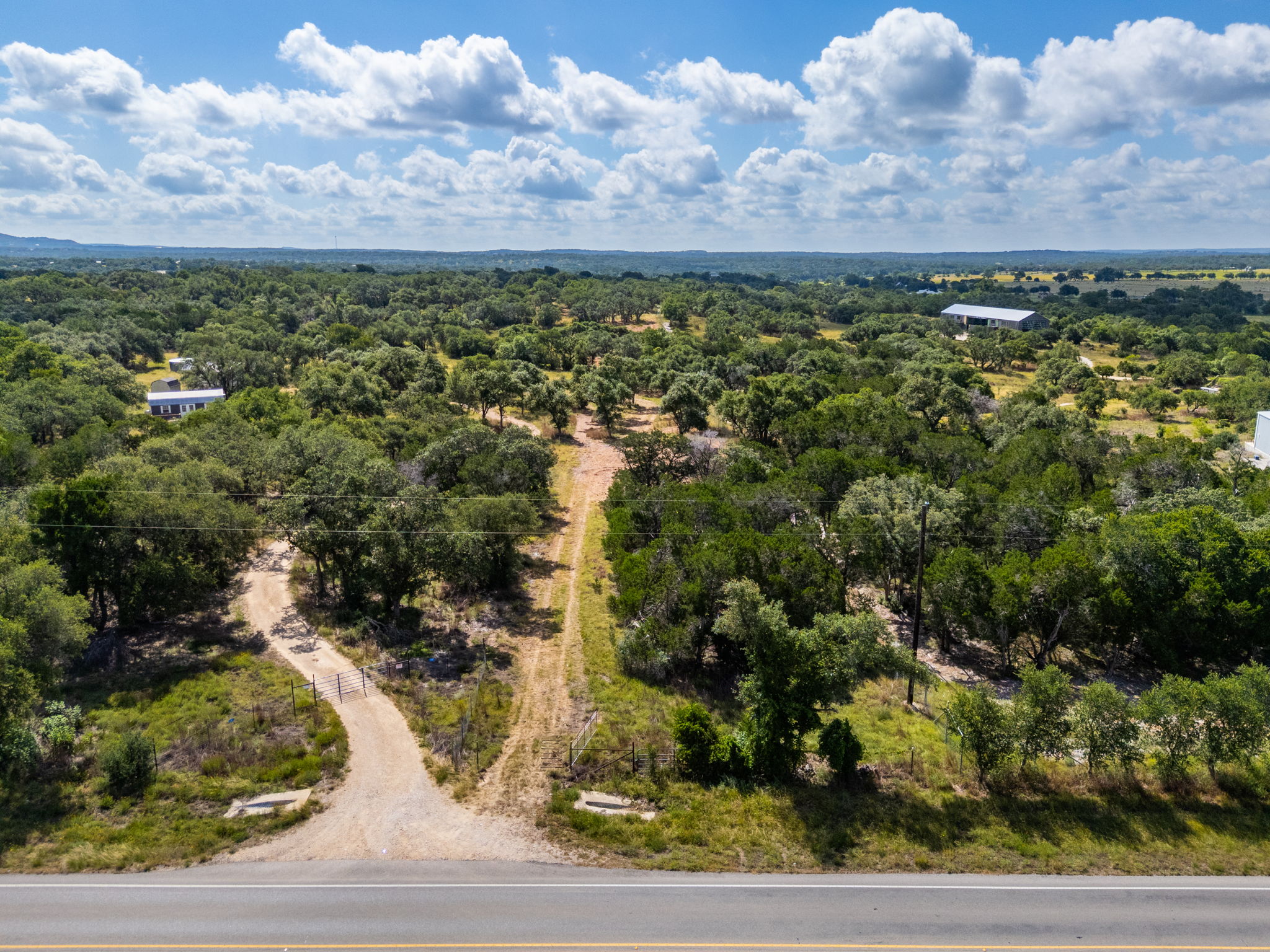 5385 Ranch Road 165 Blanco, TX 78606 - Photo 20 of 40 A sprawling landscape reveals a mix of wooded areas and cleared land, offering ample development potential.