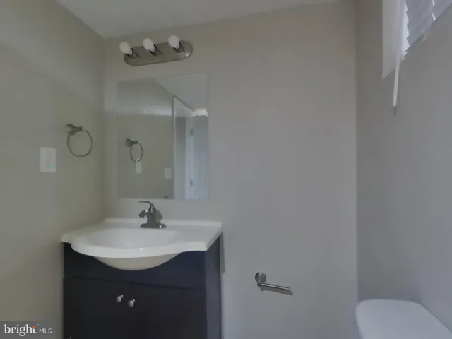 a bathroom with a sink toilet and vanity
