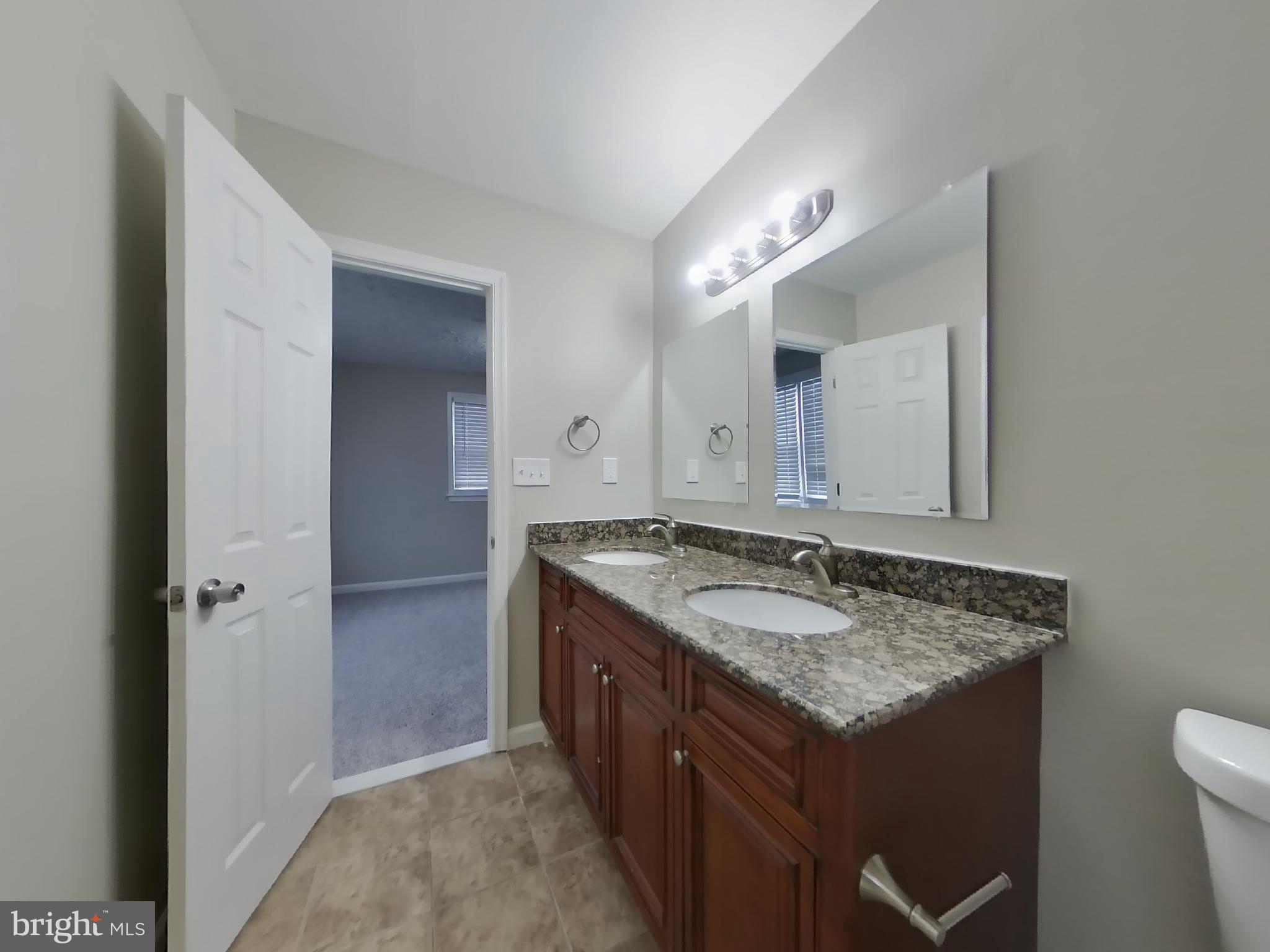 2000 Gaither Street Temple Hills, MD 20748 - Photo 8 of 21 a bathroom with a granite countertop sink and a mirror