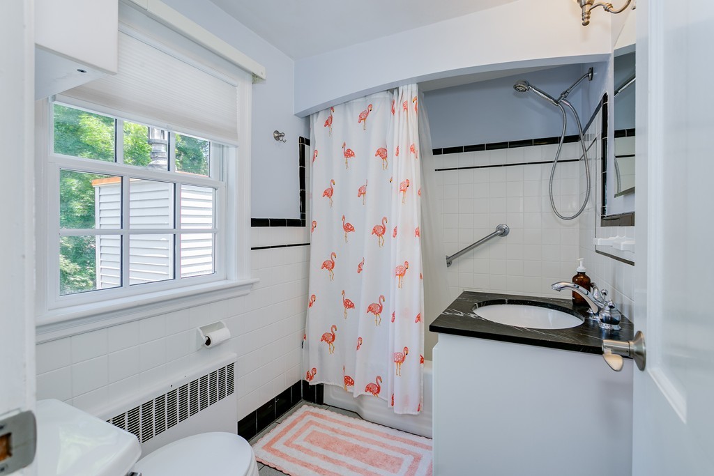 68 Chesterton Road Wellesley, MA 02481 - Photo 20 of 27 a bathroom with a sink and a shower curtain