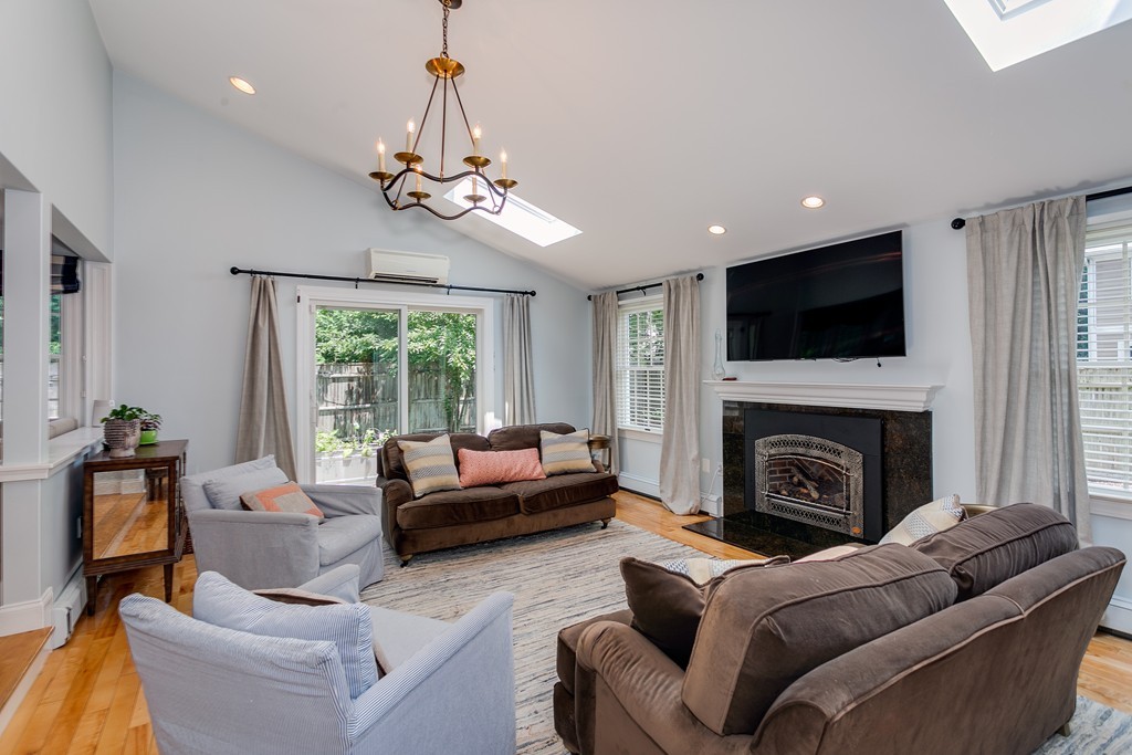 68 Chesterton Road Wellesley, MA 02481 - Photo 3 of 27 a living room with furniture a fireplace and a flat screen tv