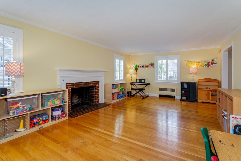 68 Chesterton Road Wellesley, MA 02481 - Photo 10 of 27 a living room with fireplace furniture and a wooden floor
