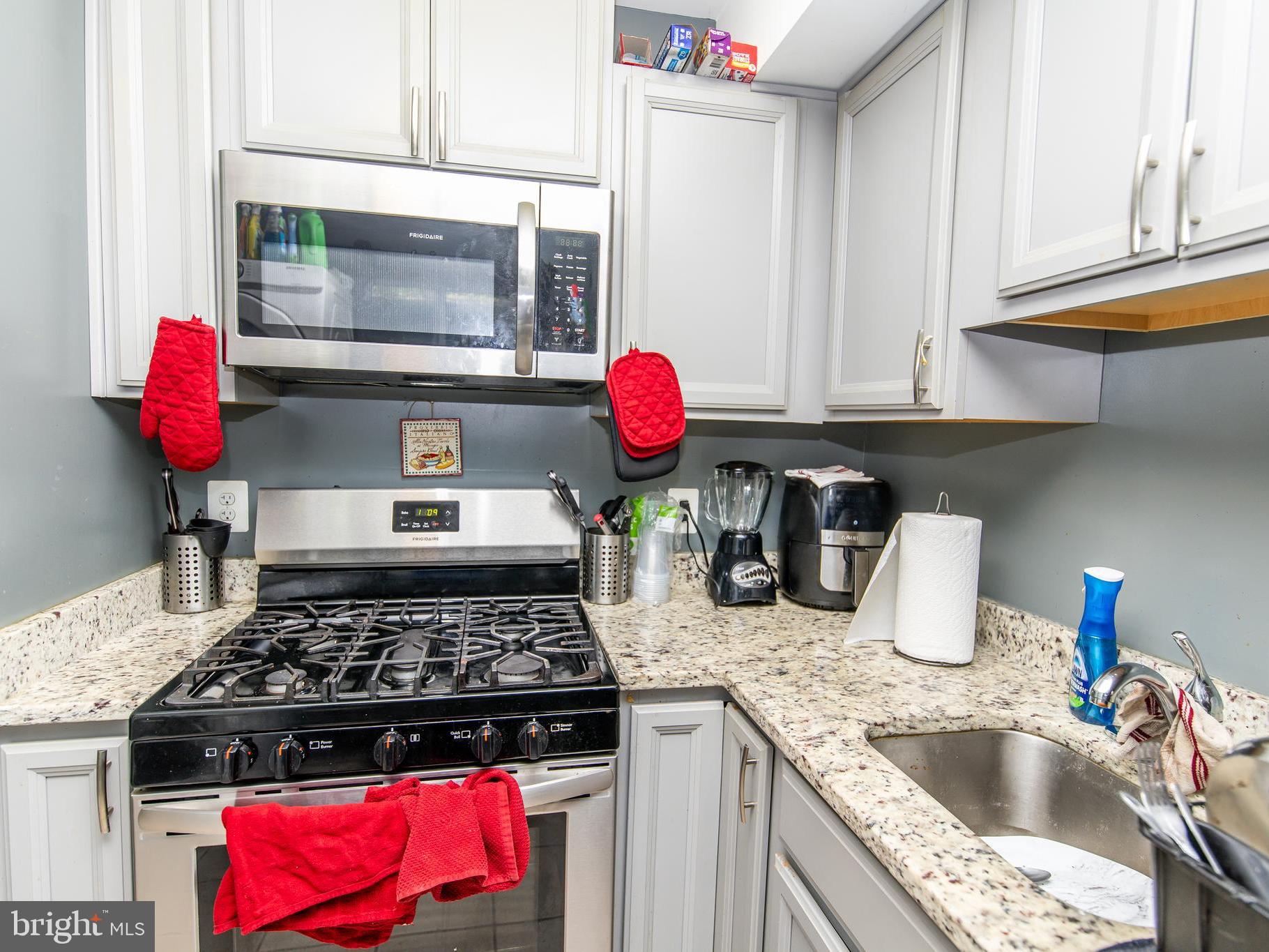 3934 Bel Pre Road, Unit 39342 Silver Spring, MD 20906 - Photo 8 of 30 a kitchen with stainless steel appliances granite countertop a stove and a sink