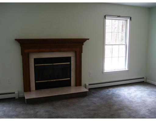 24 Baker Road Salisbury, MA 01952 - Photo 8 of 8 a living room with a fireplace in it