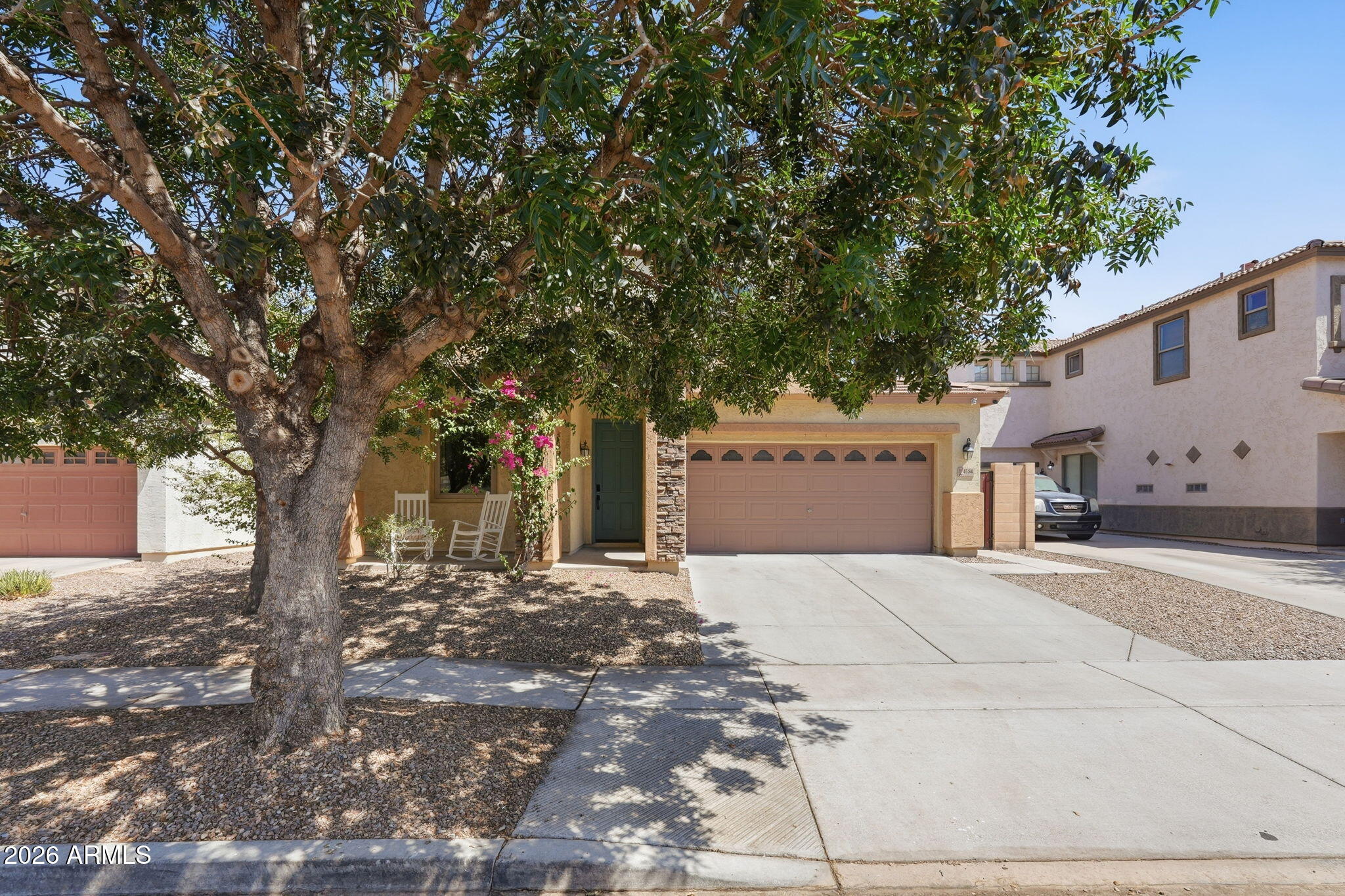 4184 East Trigger Way Gilbert, AZ 85297 - Photo 8 of 51 a front view of a house with a yard and garage