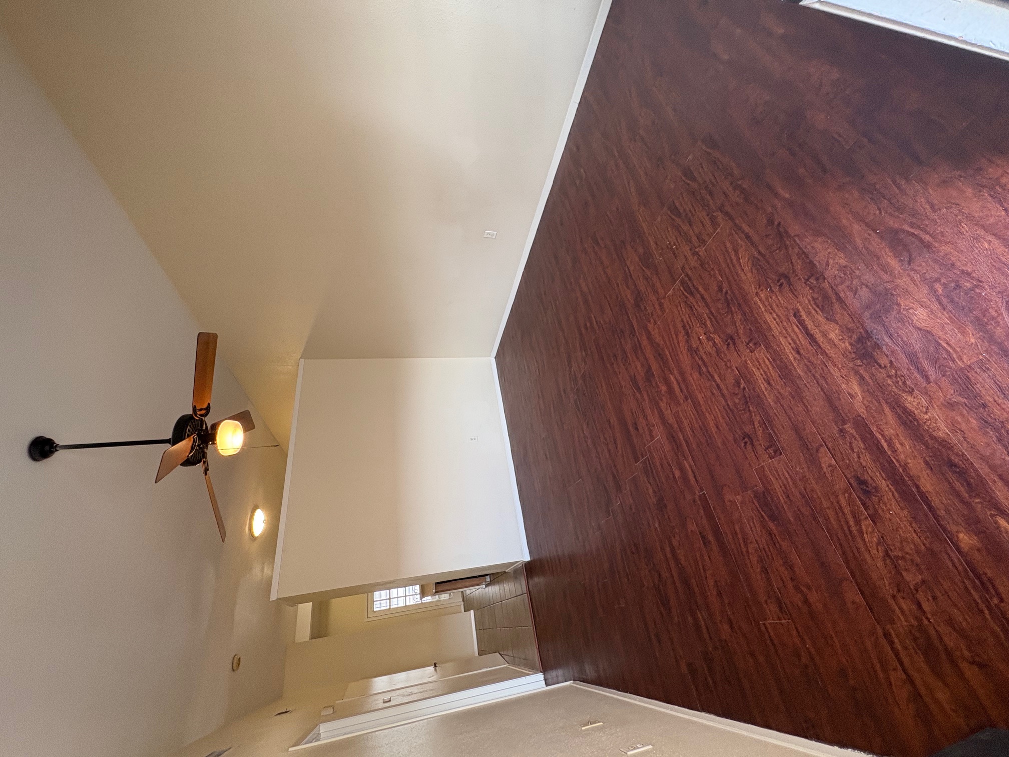 2801 Rio Grande Street, Unit 303 Austin, TX 78705 - Photo 5 of 11 Empty room with dark wood-style flooring and a ceiling fan