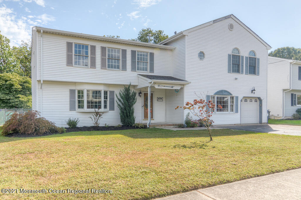 313 Emberly Road Brick, NJ 08723 - Photo 1 of 32 a front view of a house with a yard