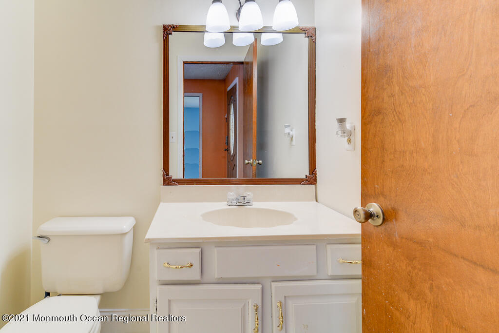 313 Emberly Road Brick, NJ 08723 - Photo 17 of 32 a bathroom with a sink and a mirror