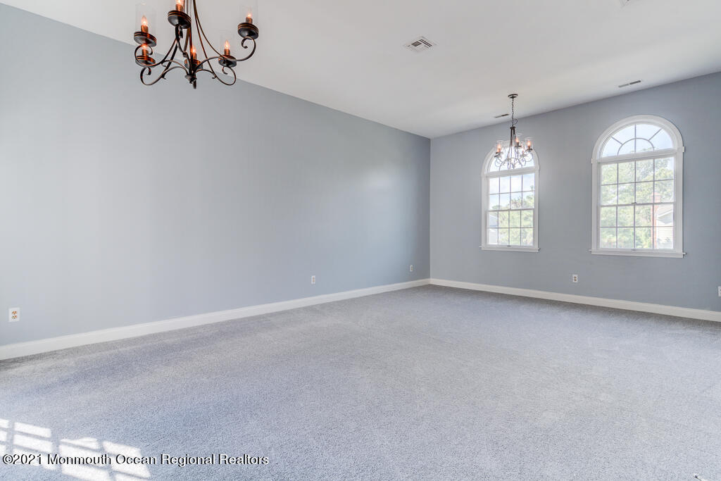 313 Emberly Road Brick, NJ 08723 - Photo 18 of 32 an empty room with windows and chandelier fan