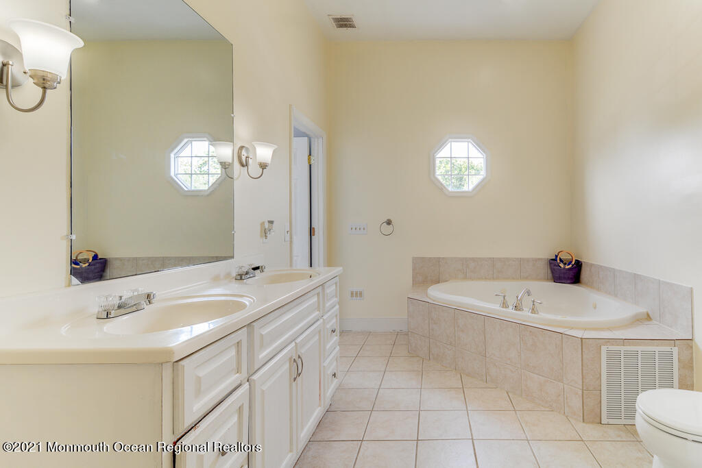 313 Emberly Road Brick, NJ 08723 - Photo 21 of 32 a bathroom with a sink a tub and a mirror
