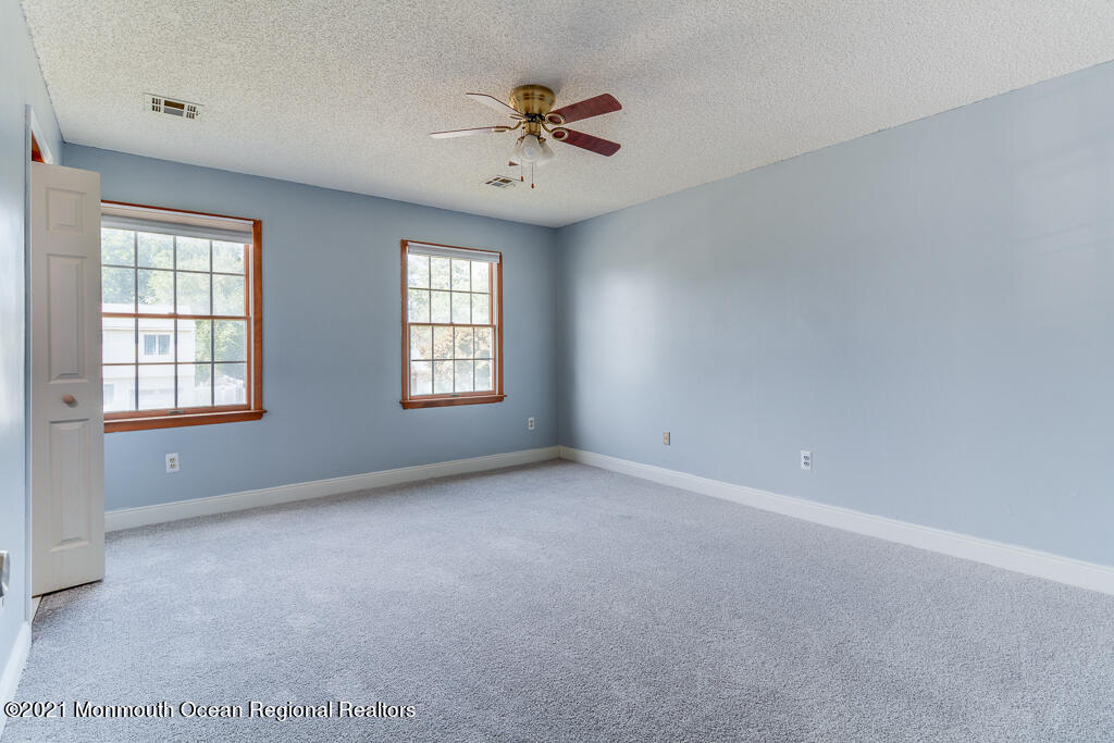 313 Emberly Road Brick, NJ 08723 - Photo 22 of 32 wooden floor in an empty room with a window