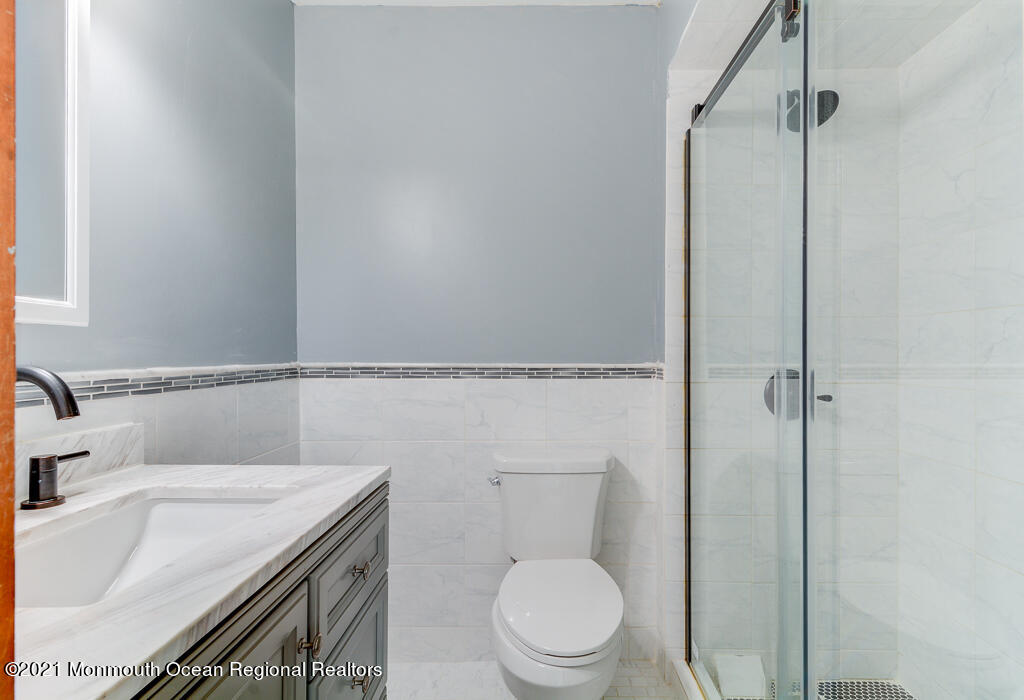 313 Emberly Road Brick, NJ 08723 - Photo 23 of 32 a bathroom with a granite countertop sink toilet and shower