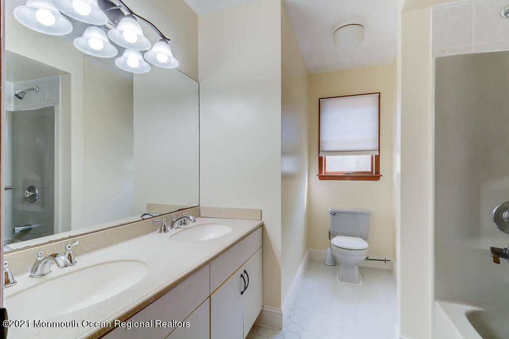313 Emberly Road Brick, NJ 08723 - Photo 27 of 32 a bathroom with a granite countertop sink a toilet and a mirror