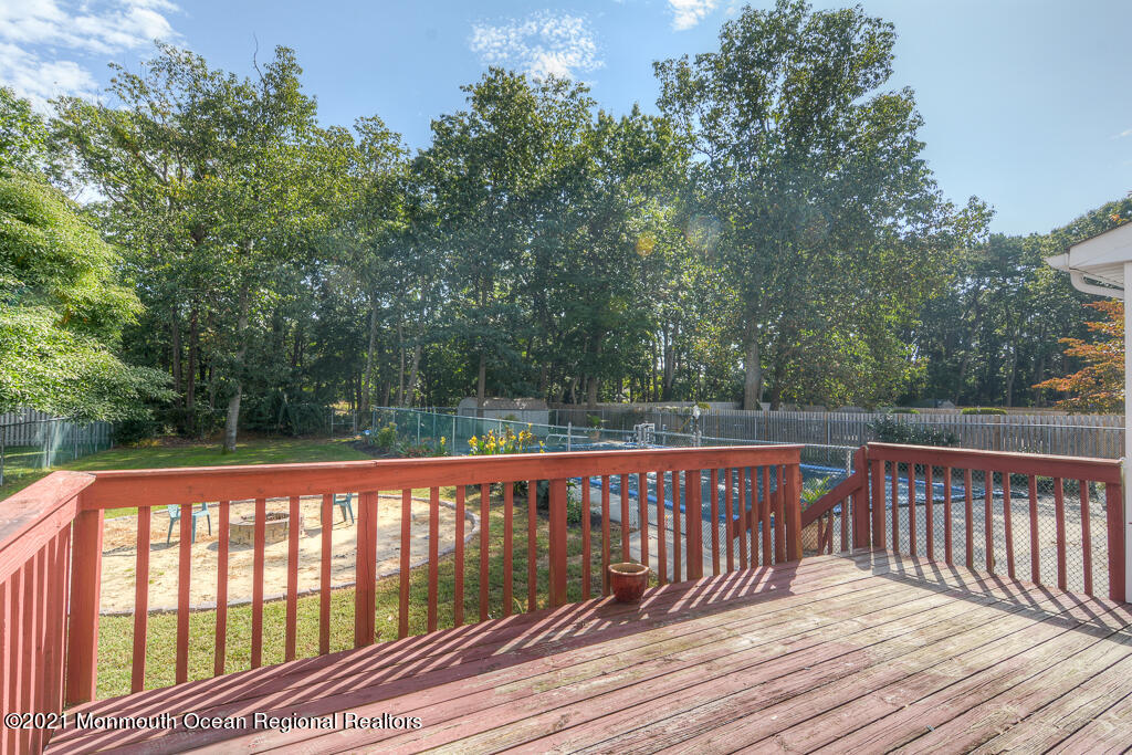 313 Emberly Road Brick, NJ 08723 - Photo 30 of 32 a balcony with wooden floor and yard in the back