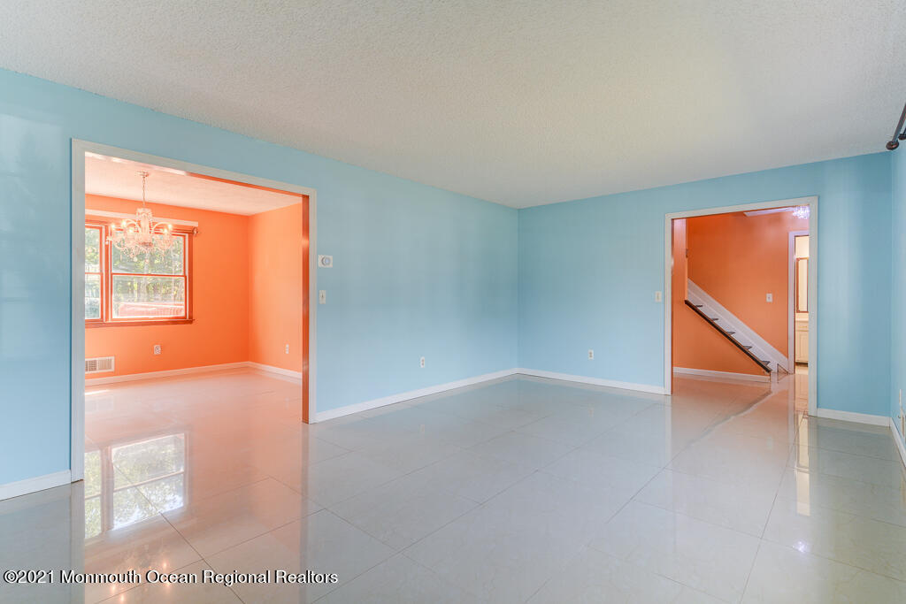 313 Emberly Road Brick, NJ 08723 - Photo 5 of 32 an empty room with wooden floor and windows