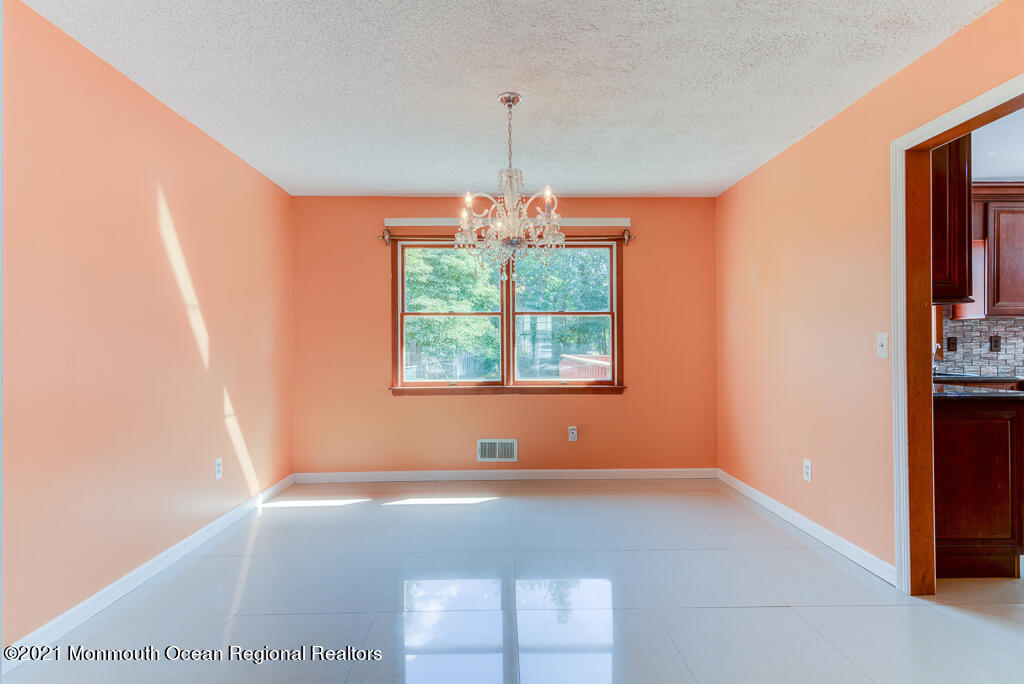 313 Emberly Road Brick, NJ 08723 - Photo 6 of 32 an empty room with windows and outdoor view
