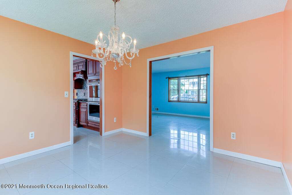 313 Emberly Road Brick, NJ 08723 - Photo 7 of 32 a view of a hallway with windows and chandelier