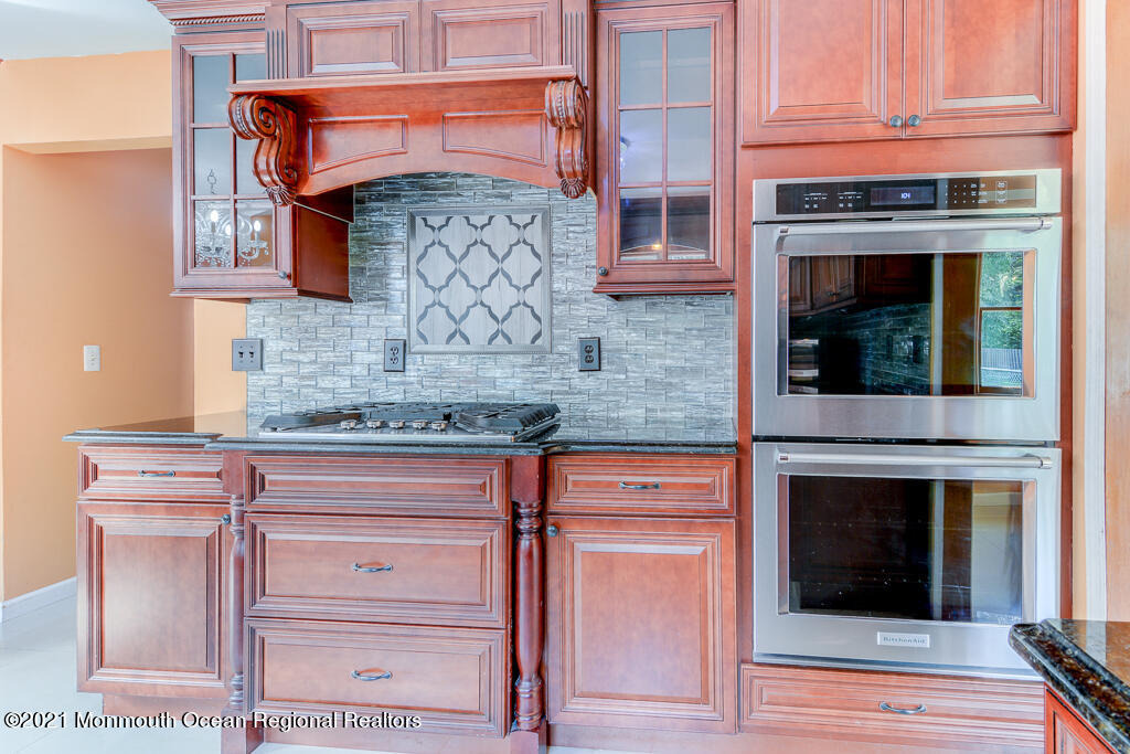 313 Emberly Road Brick, NJ 08723 - Photo 10 of 32 a kitchen with granite countertop white cabinets and stainless steel appliances