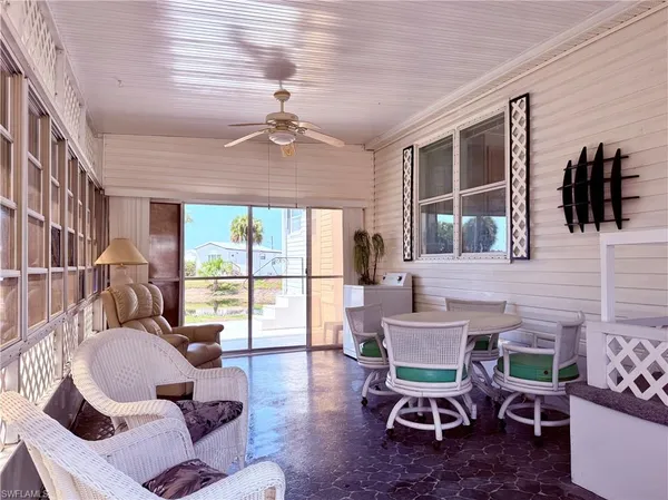 a dining room with furniture a rug and a large window